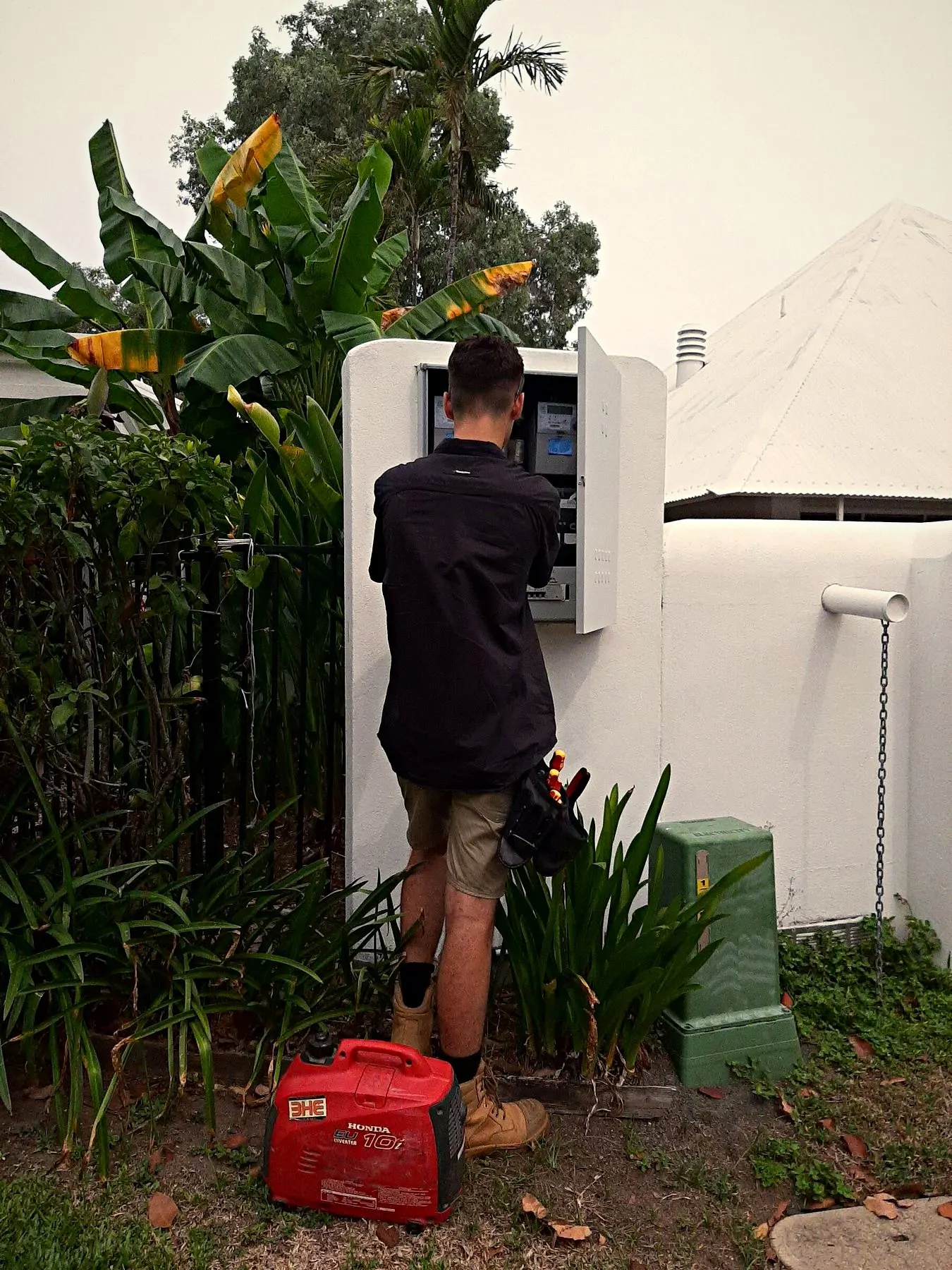 A BH Electrics electrician working on an outdoor meter box