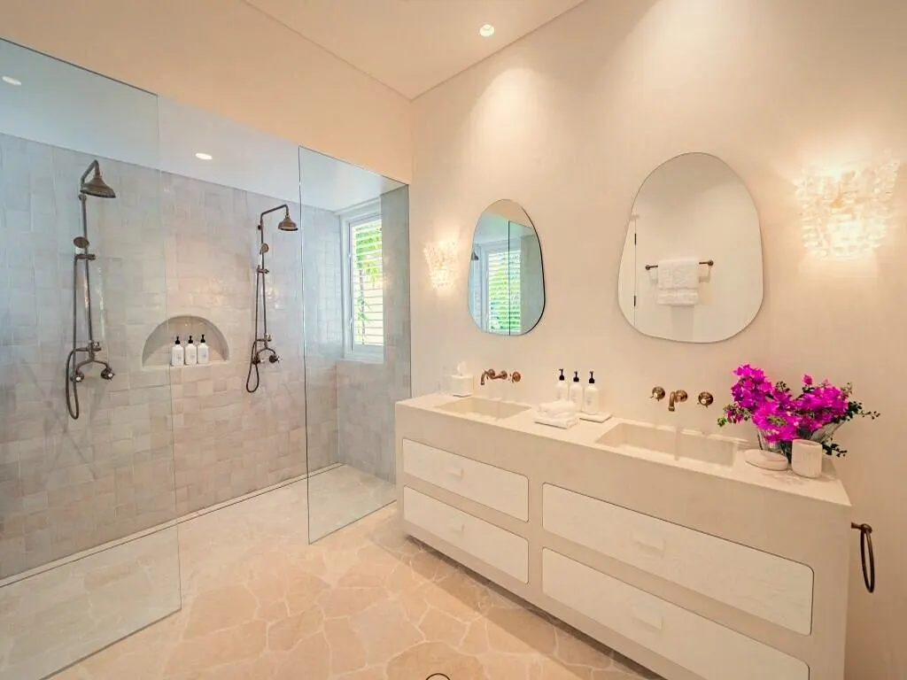 A finished bathroom with wall lighting and heated fittings