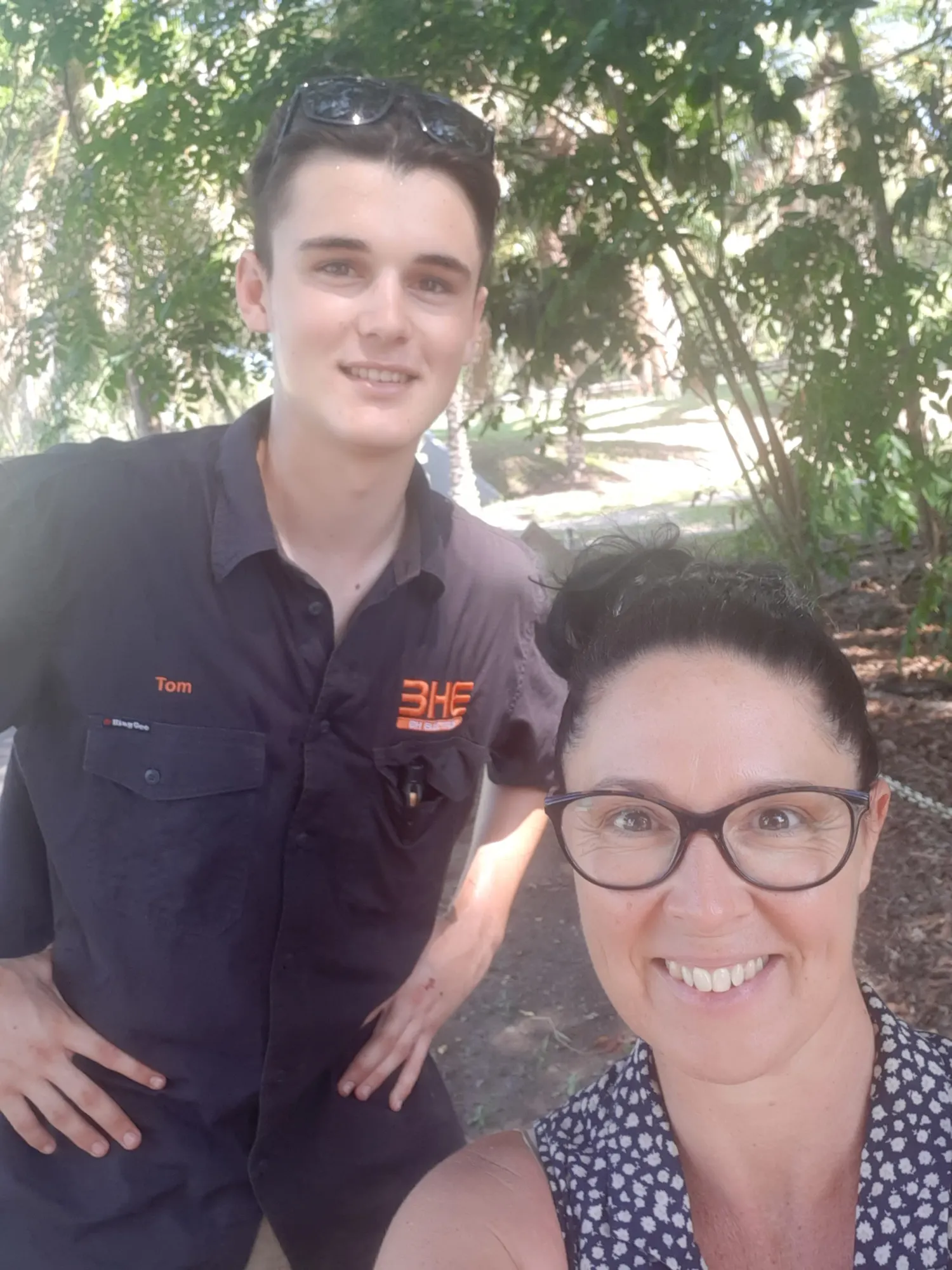 A BH Electrics apprentice and a smiling customer outside her Port Douglas home