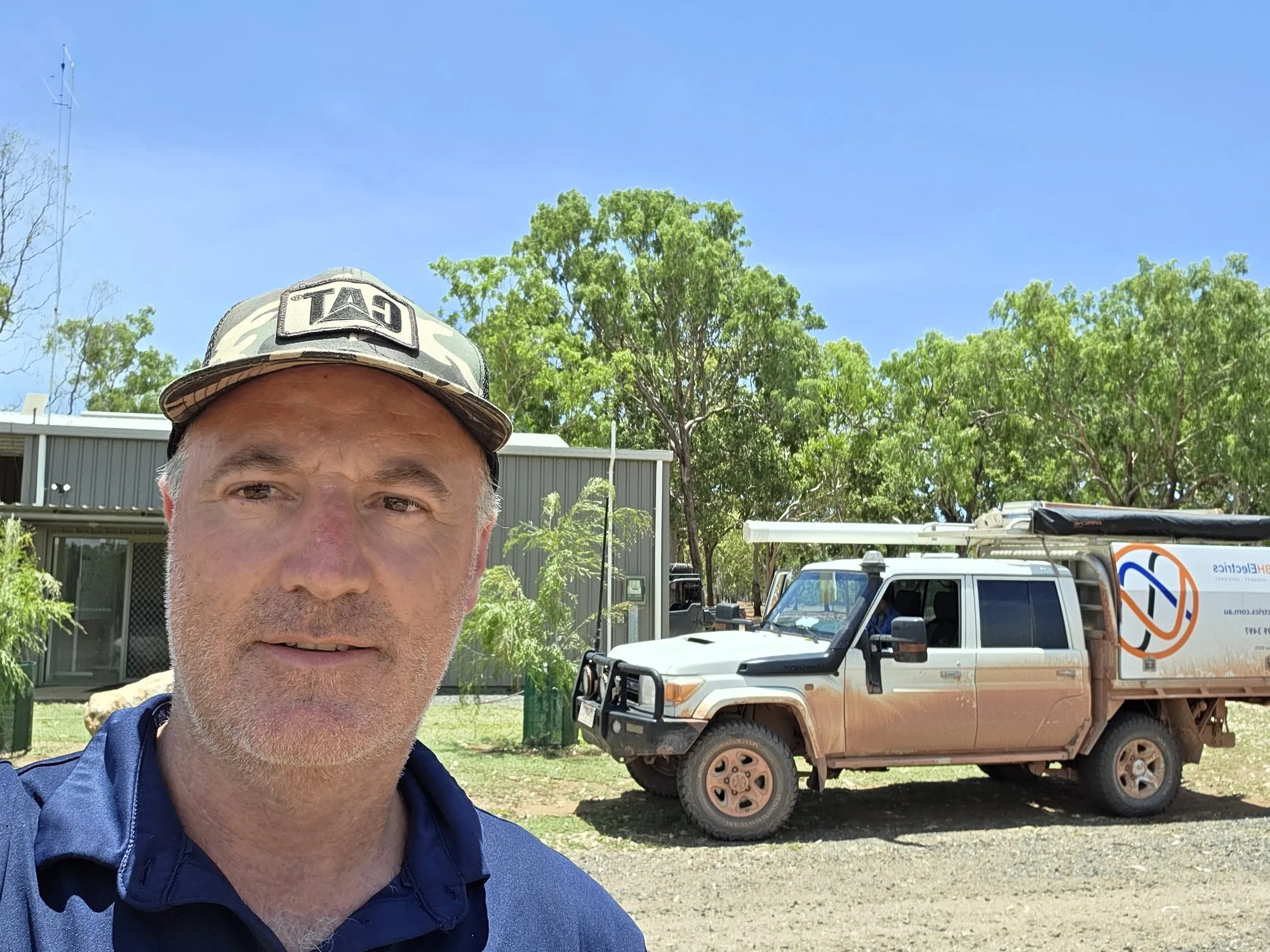 Brad Sims at a remote ranger station, with the mud-covered BH Electrics four wheel drive parked behind him
