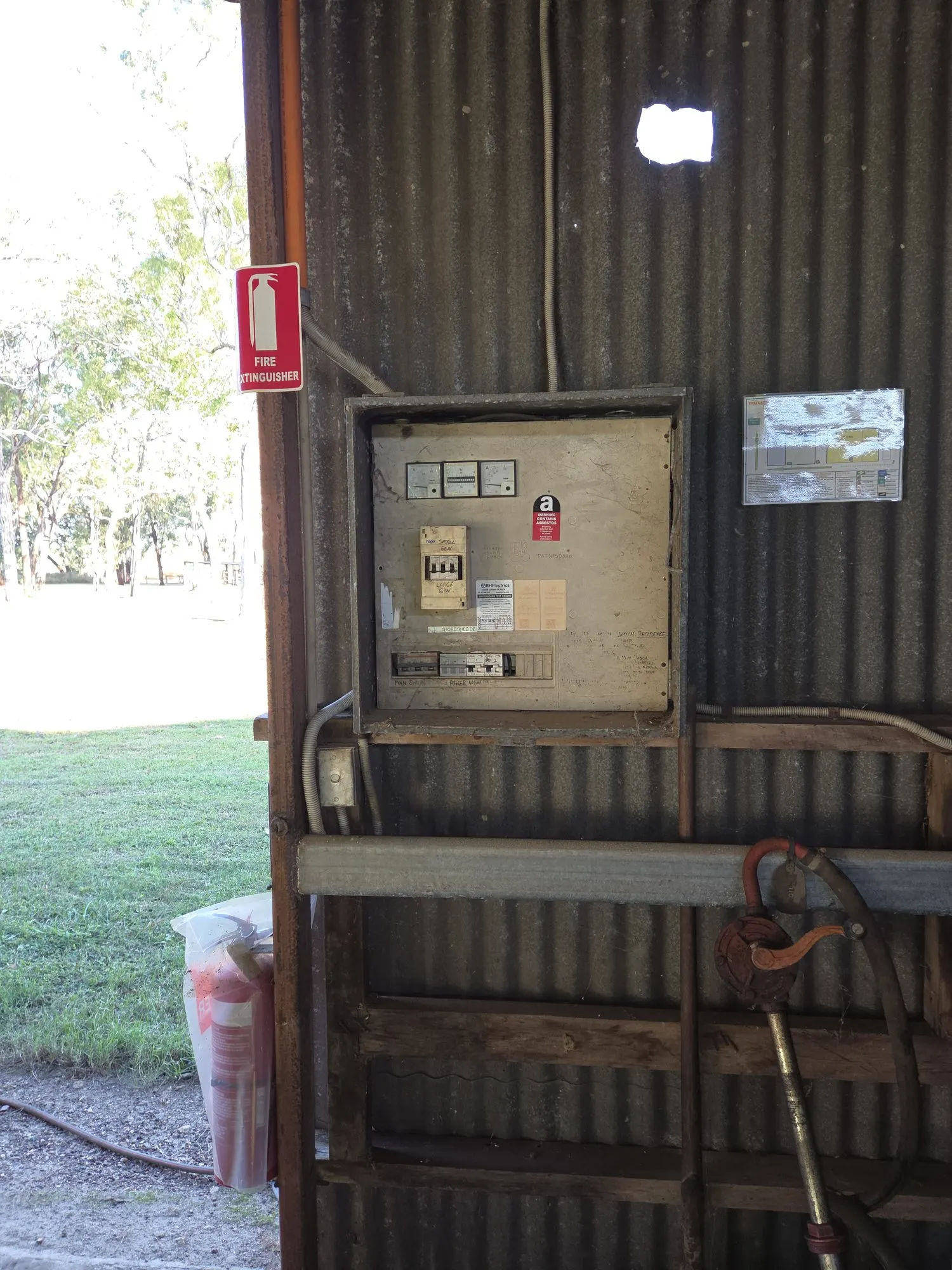 An old switchboard in a remote station shed, labelled by hand for the small and large generators, carrying a BH Electrics test record