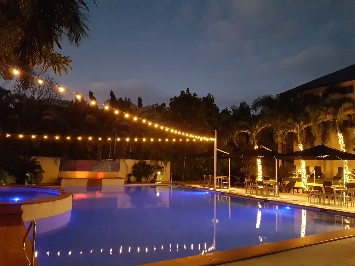Festoon lighting over the pool at Central Plaza Apartments, Port Douglas, after dark