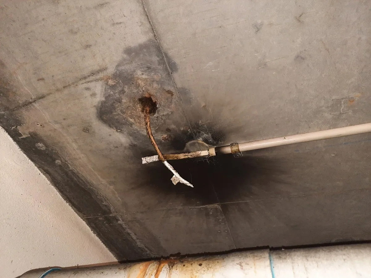 Heavy scorching across a ceiling where a cable has burnt through