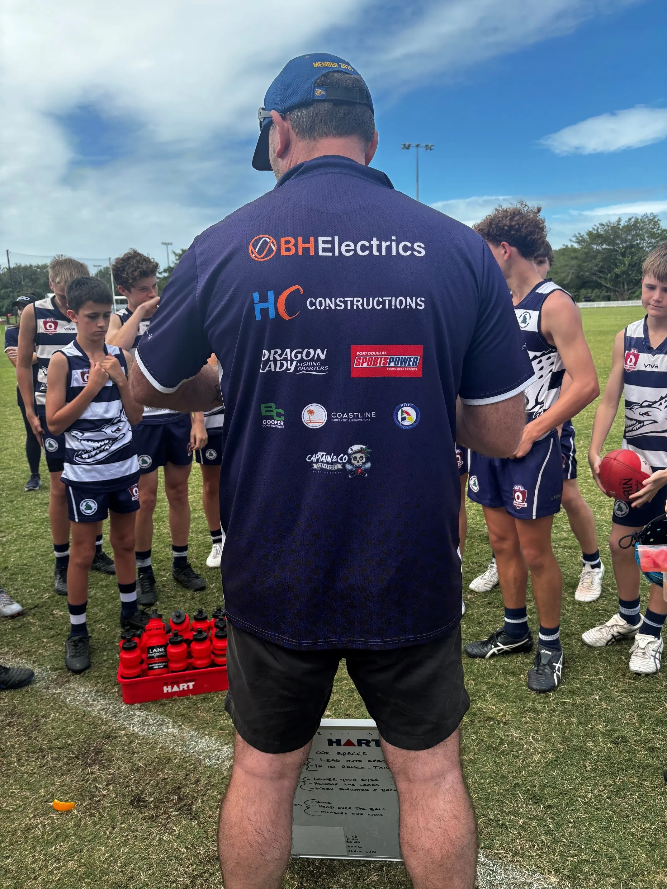 Bryce Madgwick coaching the Port Douglas Crocs Under 15s, wearing a BH Electrics sponsor shirt