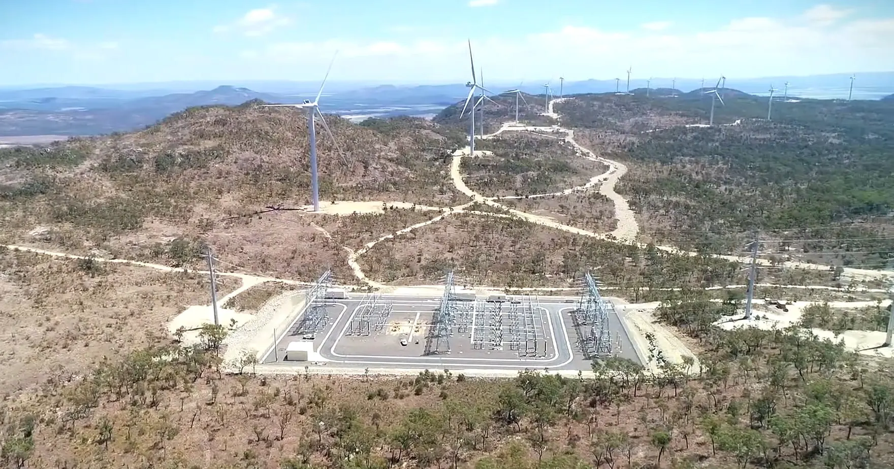 Mount Emerald Wind Farm from the air, the substation in the foreground and turbines along the ridges of the Atherton Tablelands behind