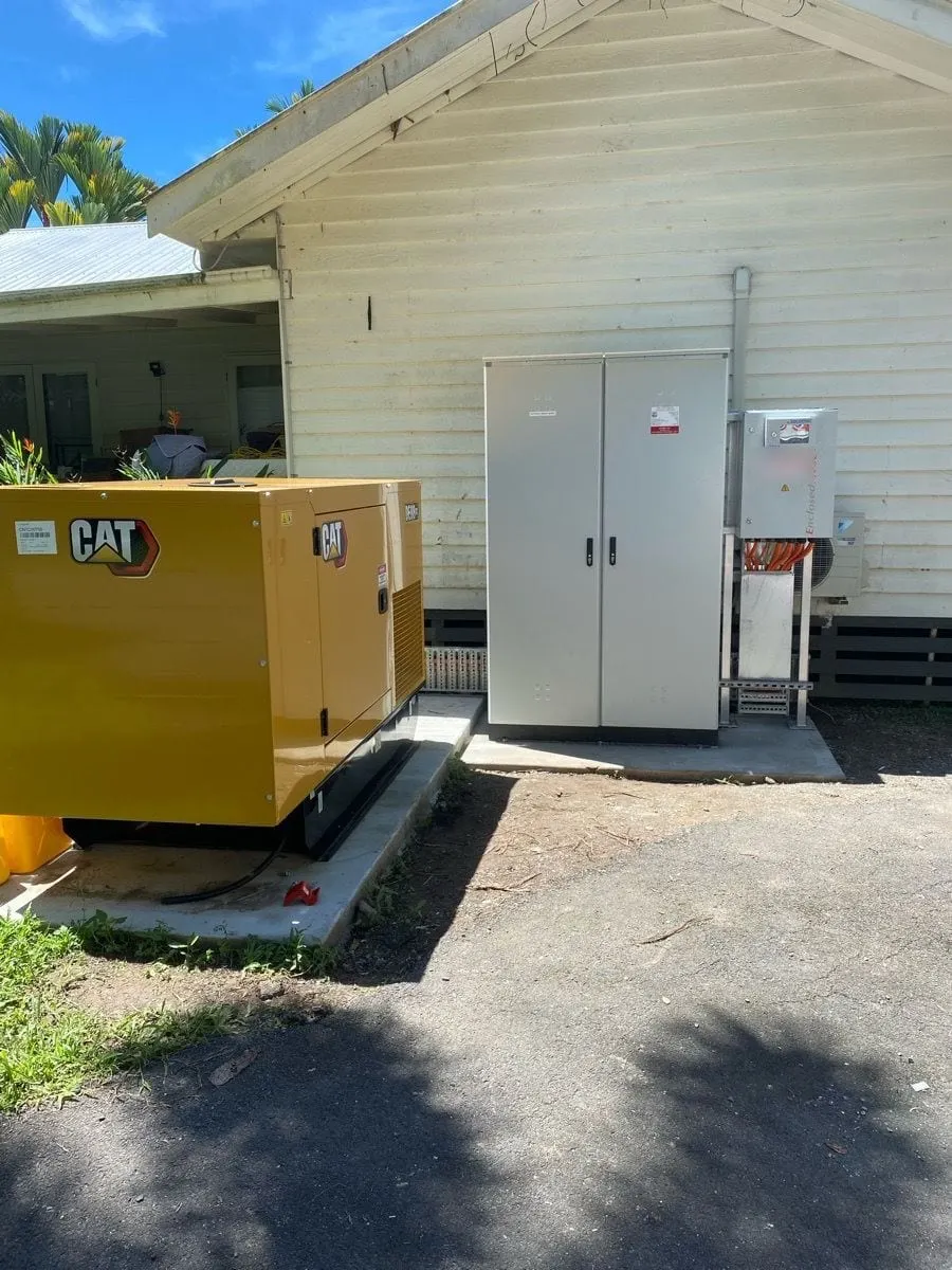 The backup generator on its slab at Mossman Resort Holiday Villas, beside the new outdoor main switchboard and the automatic changeover on its frame